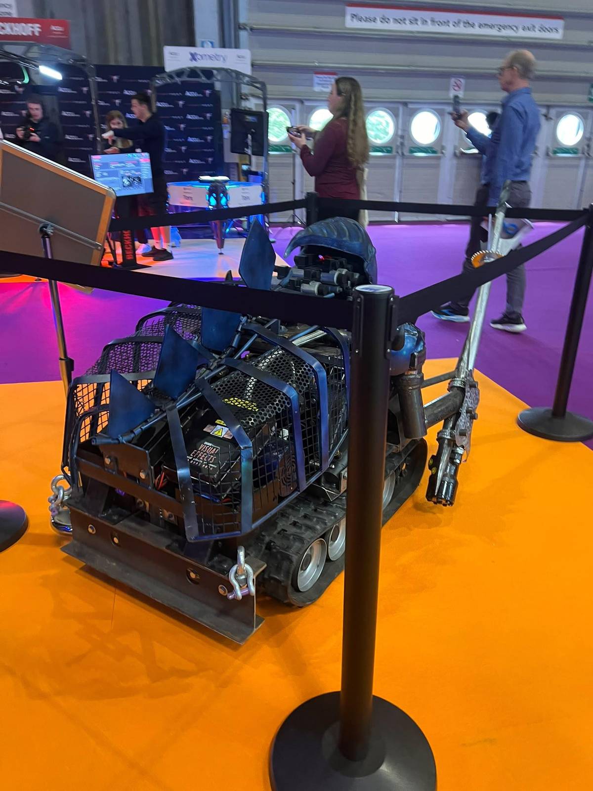 Combat robot on the orange arena floor at Accu FightFest, Smart Manufacturing Week